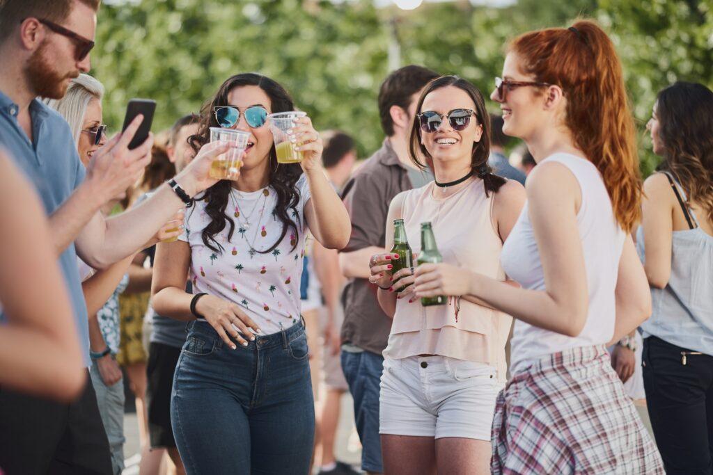 Gäste feiern draußen bei Drinks und Musik | Stühle mieten